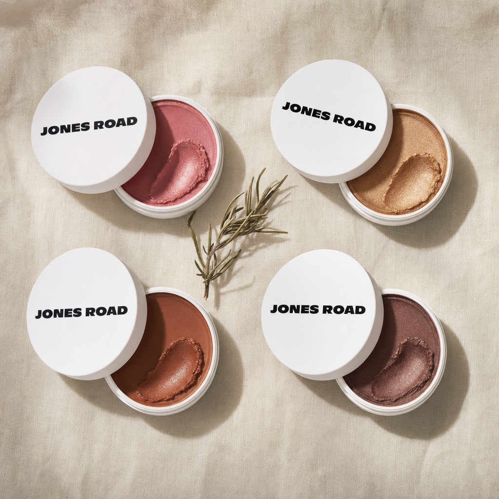 Top-down flat lay of four open Miracle Balm pots in Dusty Rose, Golden Hour, Bronze, and Cocoa Bronze shades on a warm linen surface